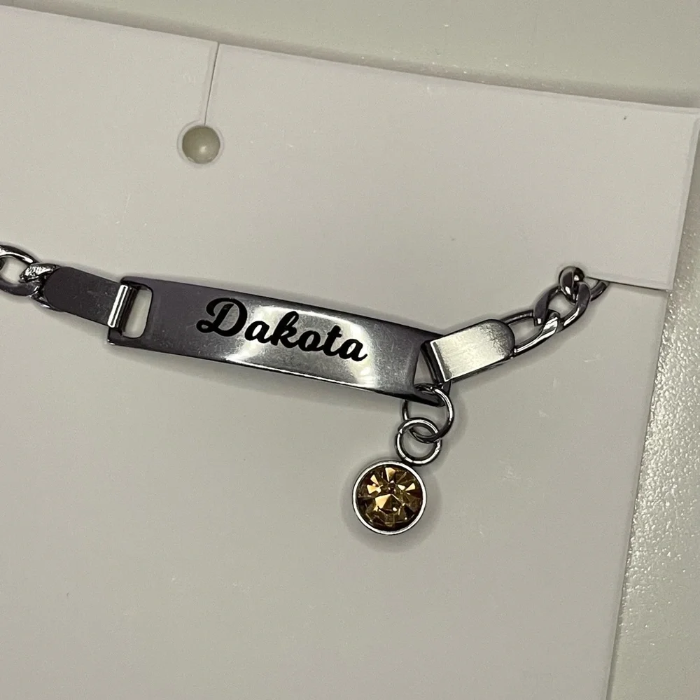“Dakota” Baby/ Kid’s Silver Metal Name Bracelet with Orange Rhinestone Charm